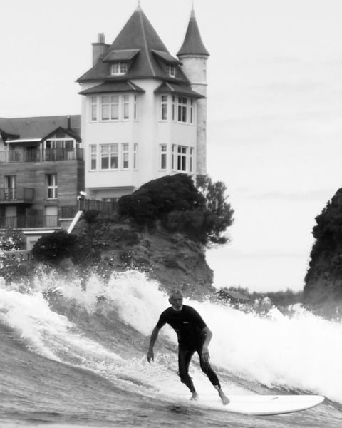 Laurent Inne surfing in front of the Villa Belza turret in Biarritz, French Basque Country