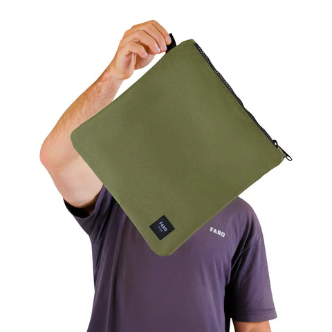 Person holding a green zippered pouch with a visible FARO logo in the lower right corner on a white background