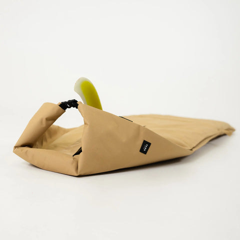 Tan surfboard bag clasp with a fin sticking out