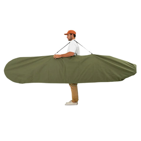 Man carrying a large green surfboard bag on a white background