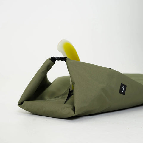 Green bag with a white and yellow fin inside on a white background